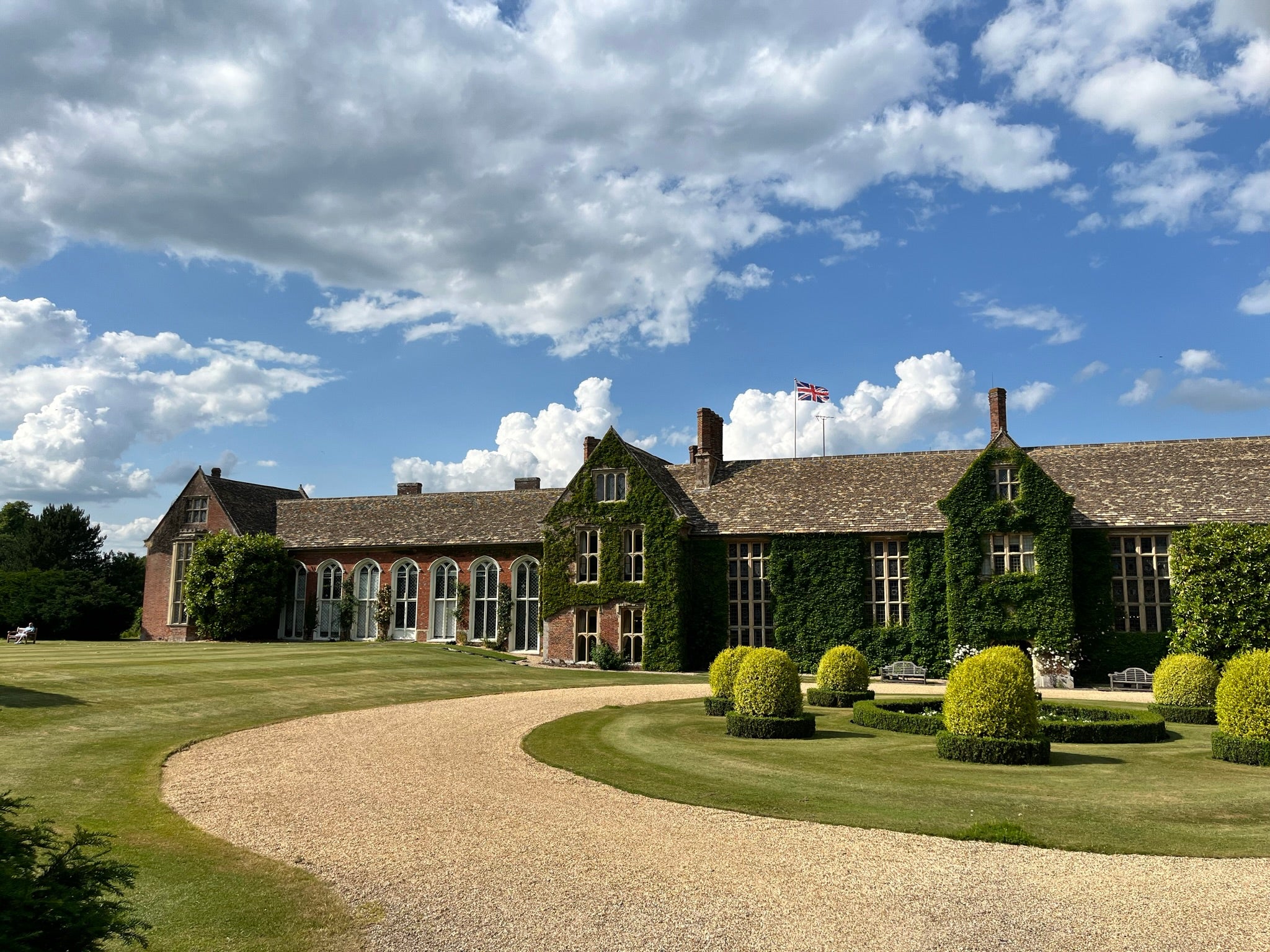 Littlecote manor house with greenery and a clear sky.